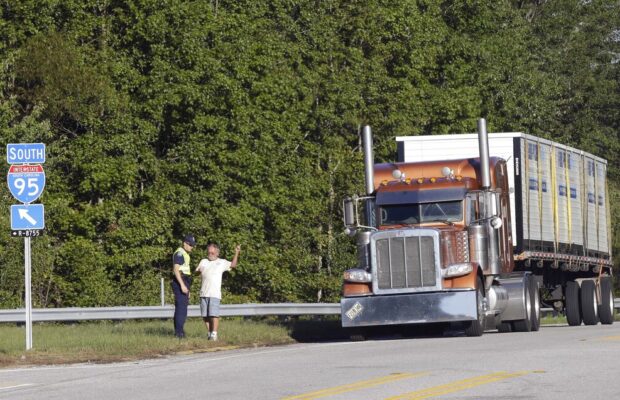 Truck Drives In Reverse Down The Highway